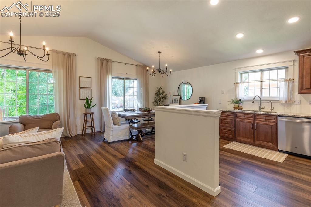 Image 13 of 41: Kitchen with a chandelier, dishwasher, plenty of natural light, vaulted cei