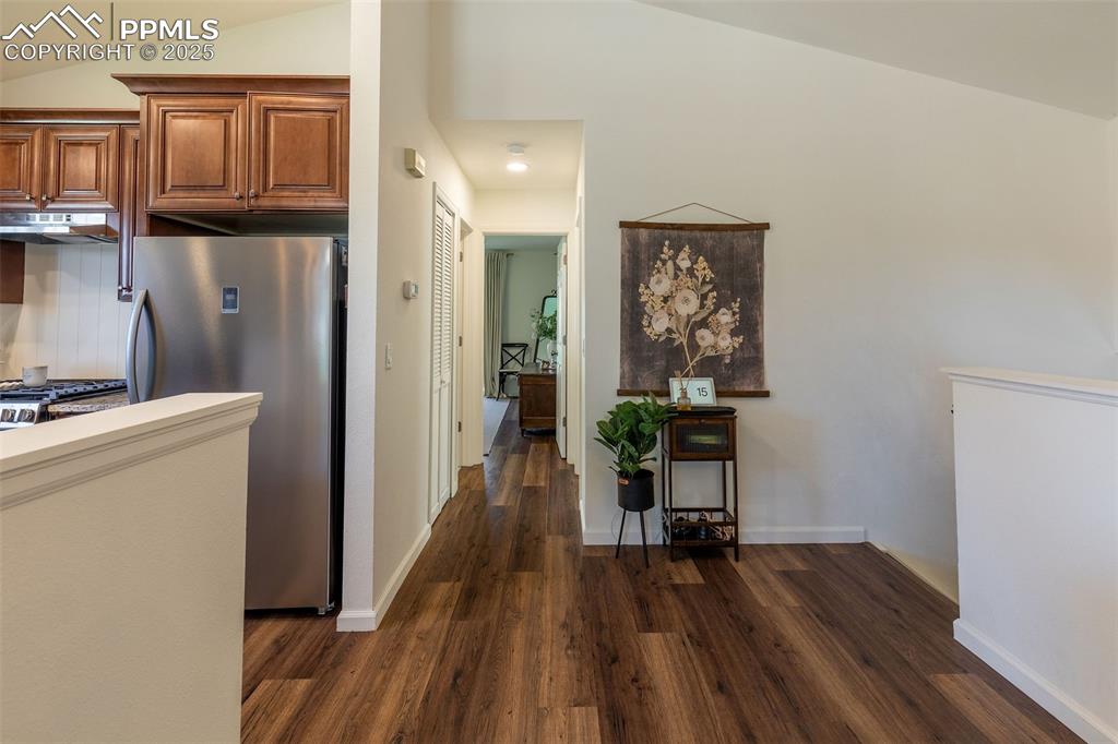 Image 16 of 41: Kitchen featuring appliances with stainless steel finishes, vaulted ceiling