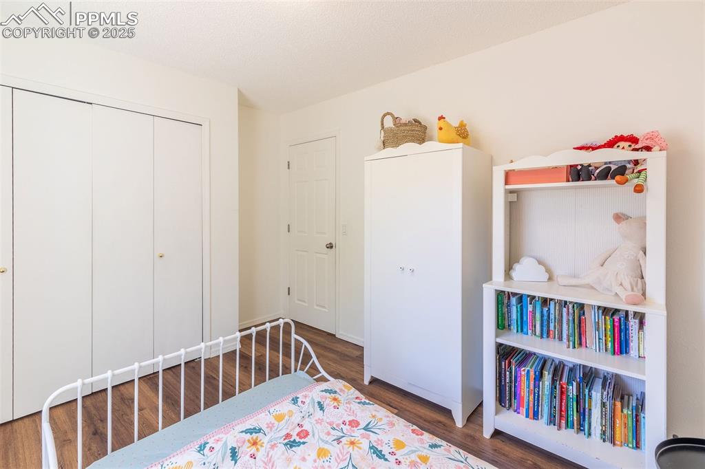 Image 19 of 41: Bedroom featuring a closet and dark wood-style floors