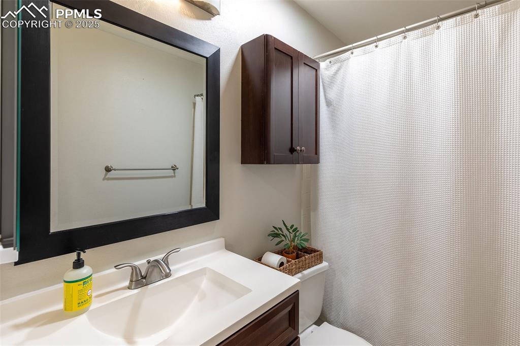 Image 20 of 41: Bathroom featuring vanity and a shower with shower curtain