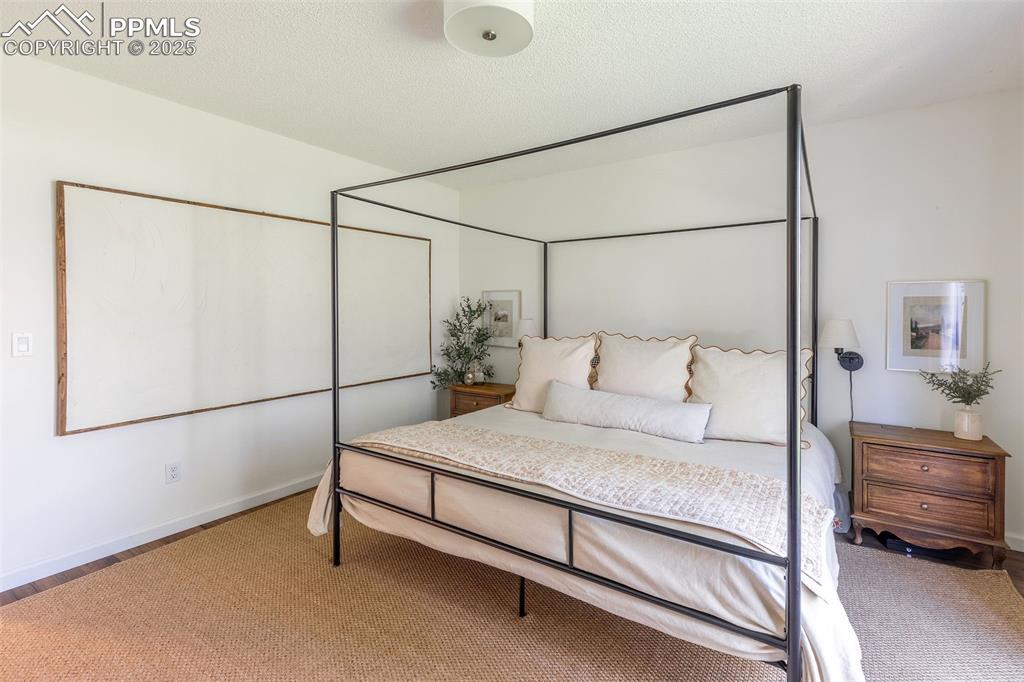 Image 22 of 41: Bedroom featuring a textured ceiling and carpet