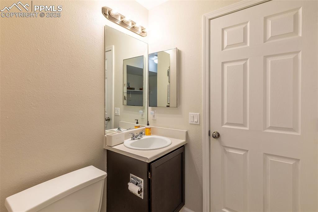 Image 29 of 41: Bathroom featuring vanity and a textured wall