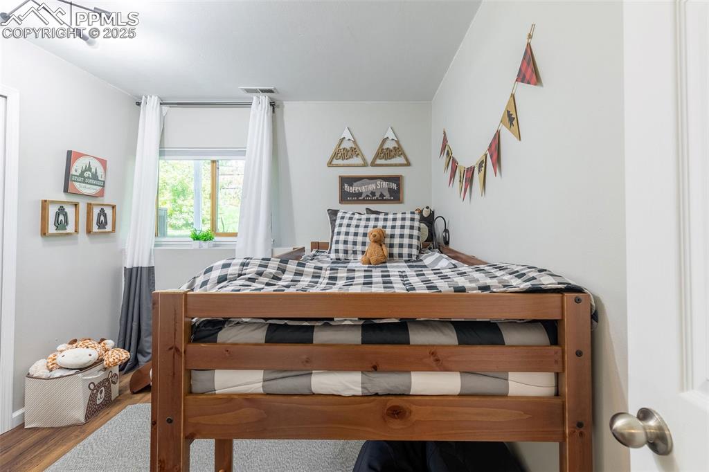 Image 32 of 41: Bedroom with wood finished floors