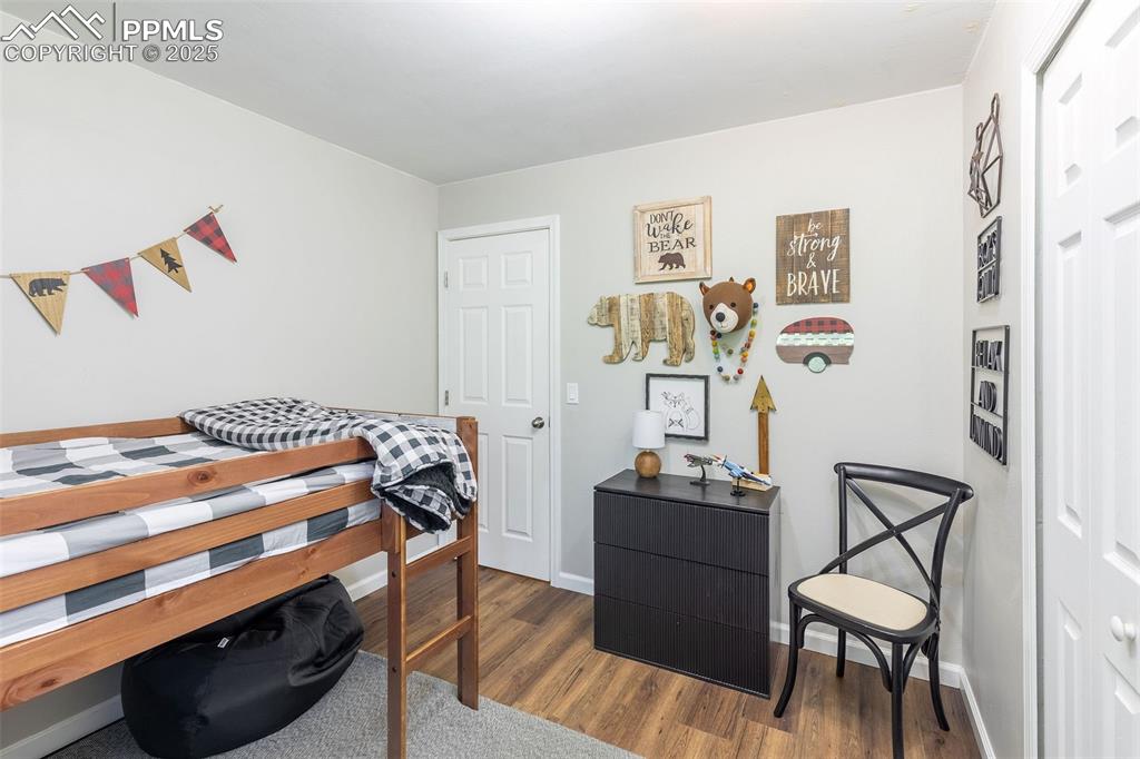 Image 34 of 41: Bedroom featuring dark wood finished floors and baseboards