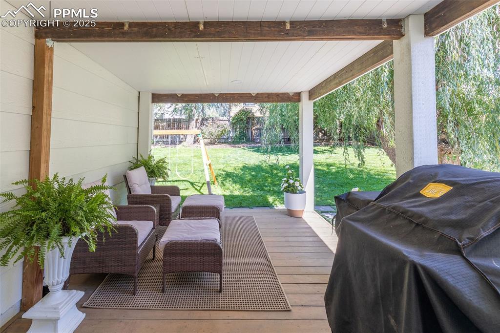 Image 35 of 41: Wooden terrace featuring a yard and a grill