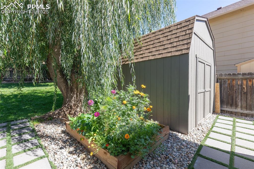 Image 37 of 41: View of shed with a garden