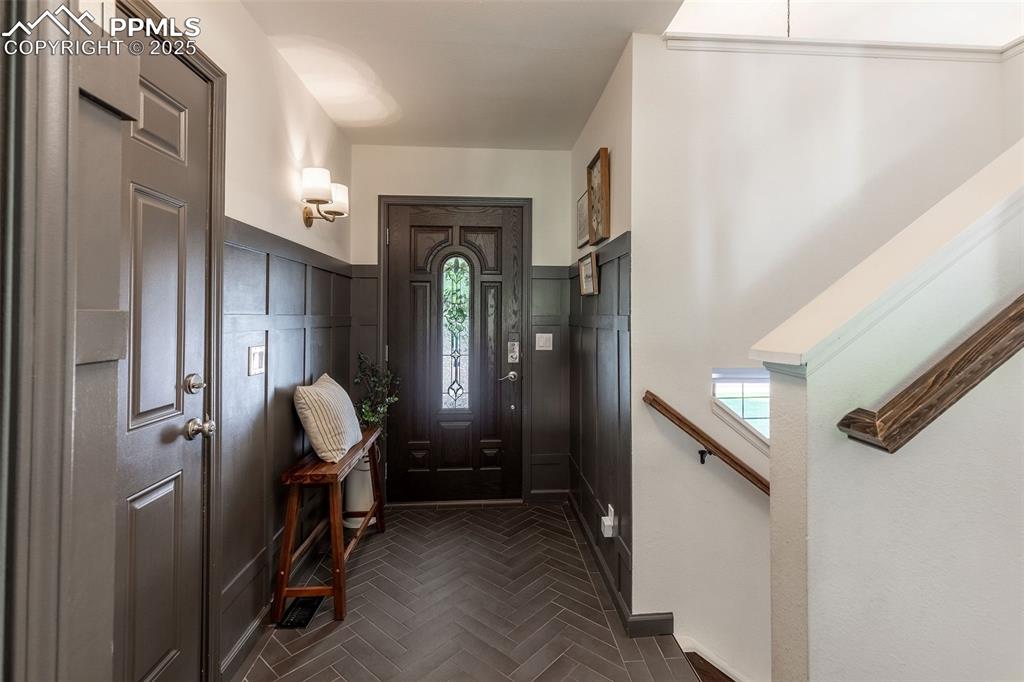 Image 4 of 41: Entryway featuring a wainscoted wall and a decorative wall