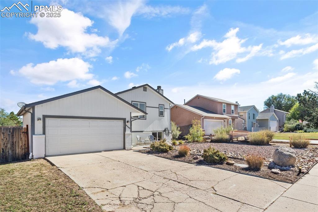Image 2 of 38: View of front of house with driveway and a garage