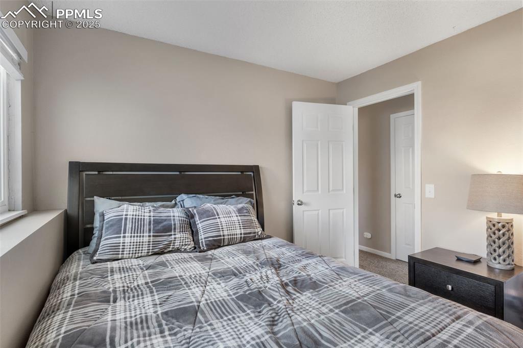 Image 24 of 38: Bedroom featuring carpet floors and a textured ceiling