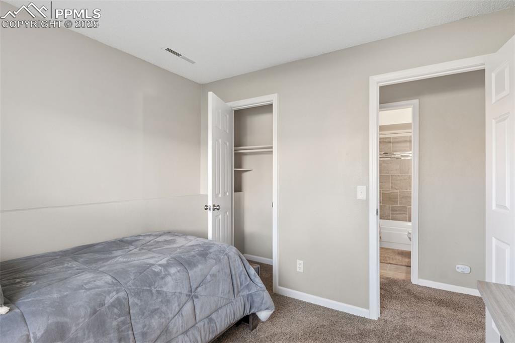 Image 26 of 38: Carpeted bedroom with baseboards and a closet