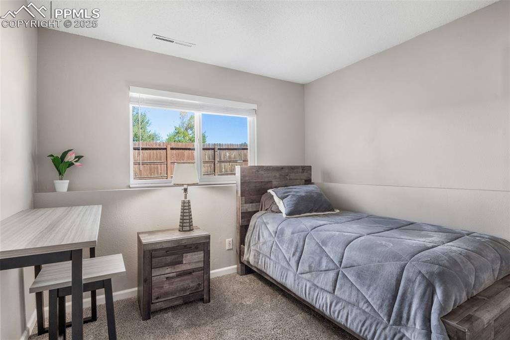 Image 27 of 38: Bedroom with carpet flooring and baseboards