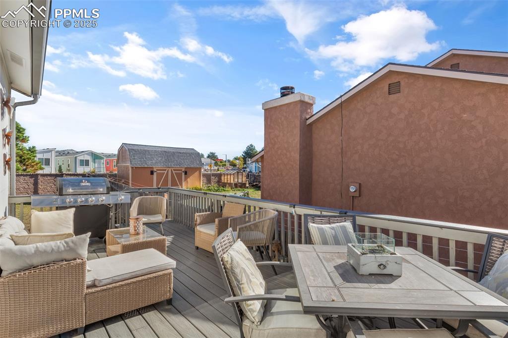 Image 29 of 38: Wooden terrace featuring outdoor dining area, an outdoor hangout area, a re