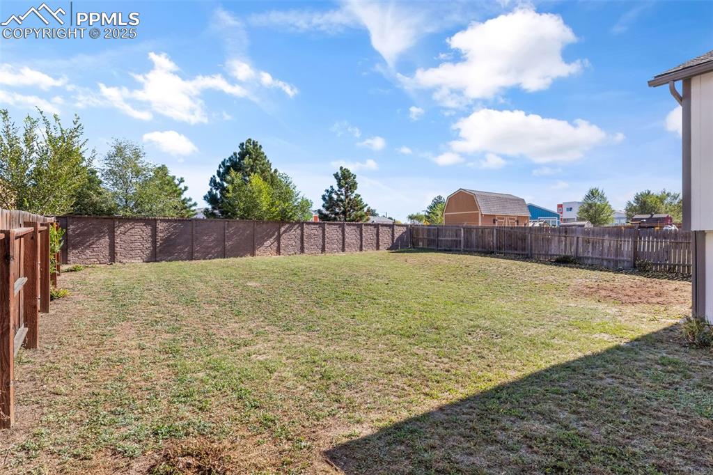 Image 33 of 38: View of fenced backyard