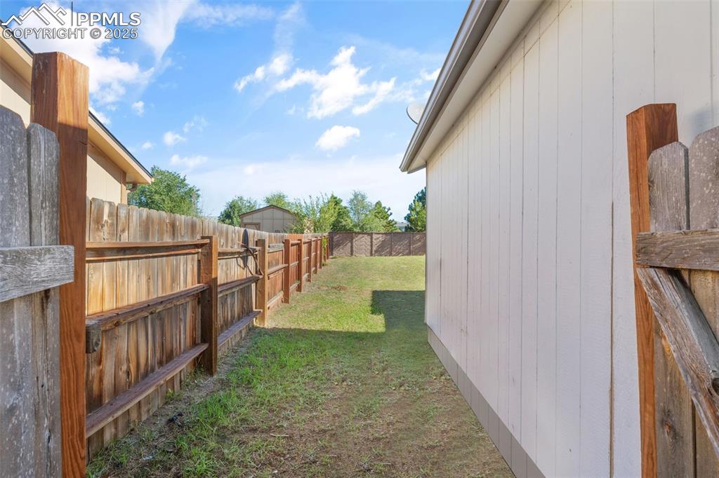 Image 34 of 38: View of fenced sideyard