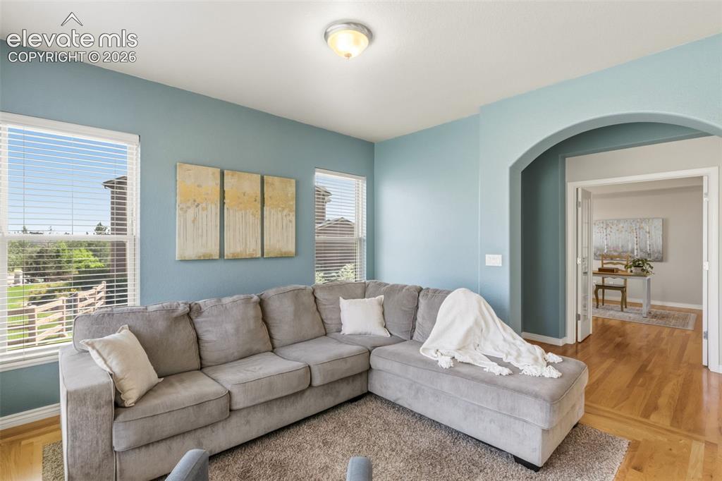 Image 10 of 47: Living space featuring light blue wall paint, multiple windows with horizon