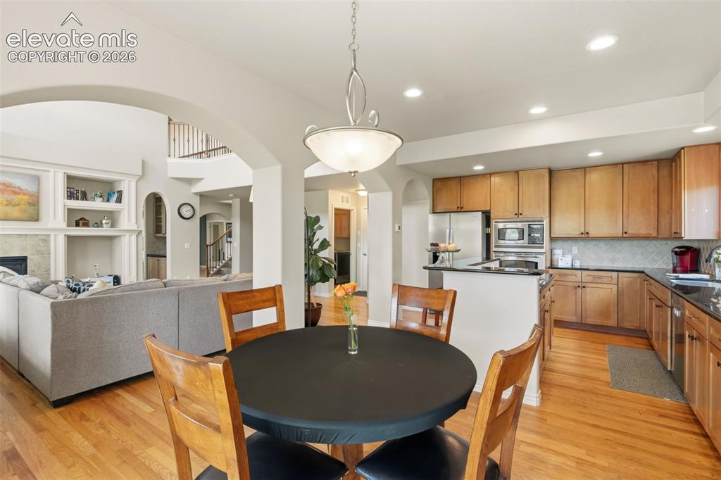 Image 15 of 47: Open-concept kitchen featuring wood cabinetry, stainless steel appliances, 