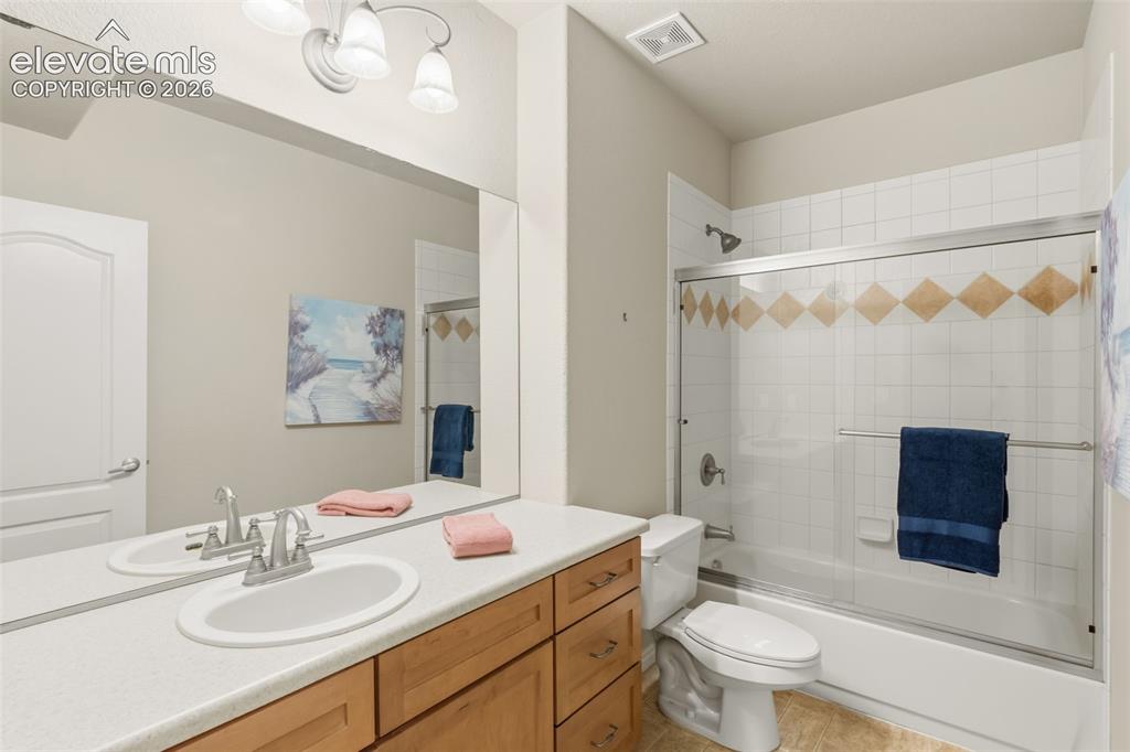 Image 37 of 47: Bathroom featuring a single vanity with a laminate countertop, wood-finish 