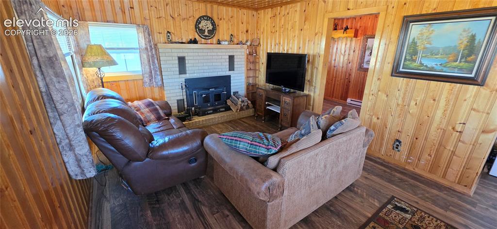 Image 3 of 35: Wood-finish flooring throughout, complemented by wood paneling on walls and