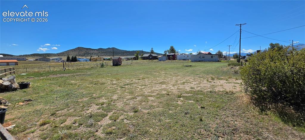 Image 30 of 35: Expansive open lot with distant mountain scenery