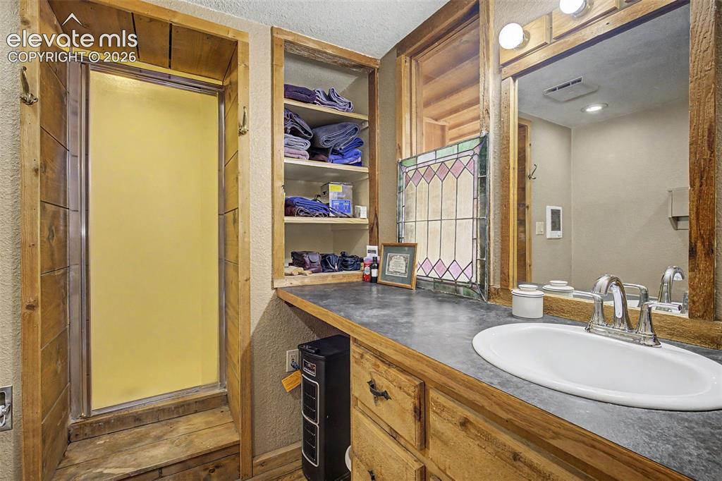 Image 20 of 34: Ensuite 3/4 bathroom with standing shower in primary