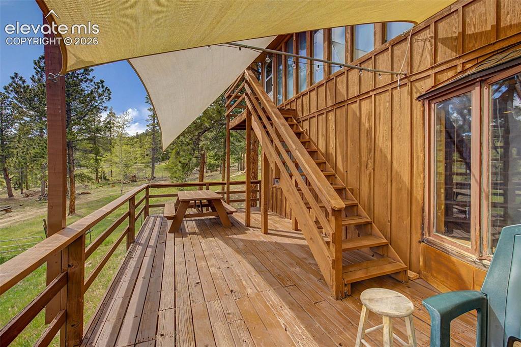 Image 21 of 34: Large deck for enjoying the mountain and wildlife view over your own meadow