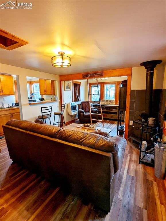 Image 13 of 21: Open concept living area featuring wood-finish flooring