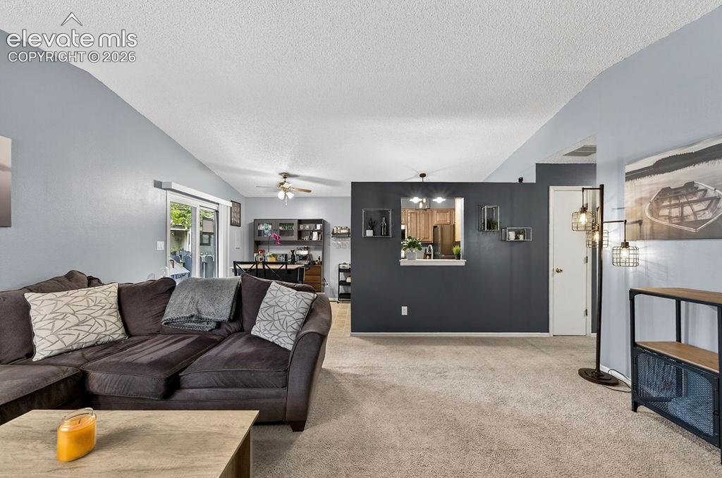 Image 11 of 50: Living room, dining area is between the living room and kitchen