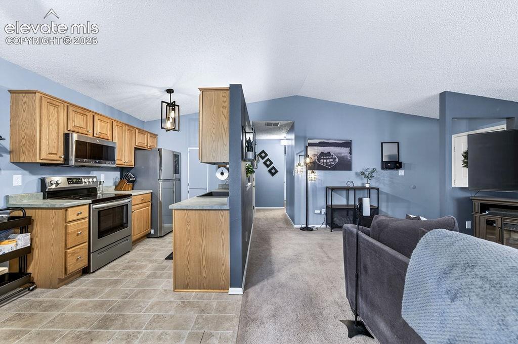 Image 12 of 50: Hallway leads to the other side of the house and the bedrooms, laundry, bat