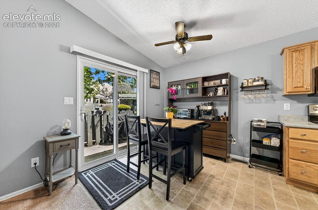 Image 13 of 50: Dining area with sliding glass door to the outside deck