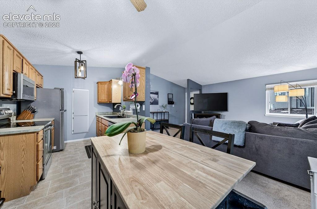 Image 15 of 50: Dining area is between the kitchen and the living room