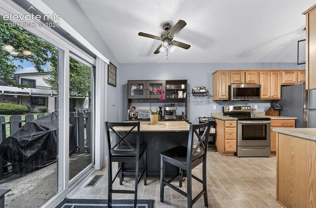 Image 17 of 50: Dining area, sliding door leads to outside