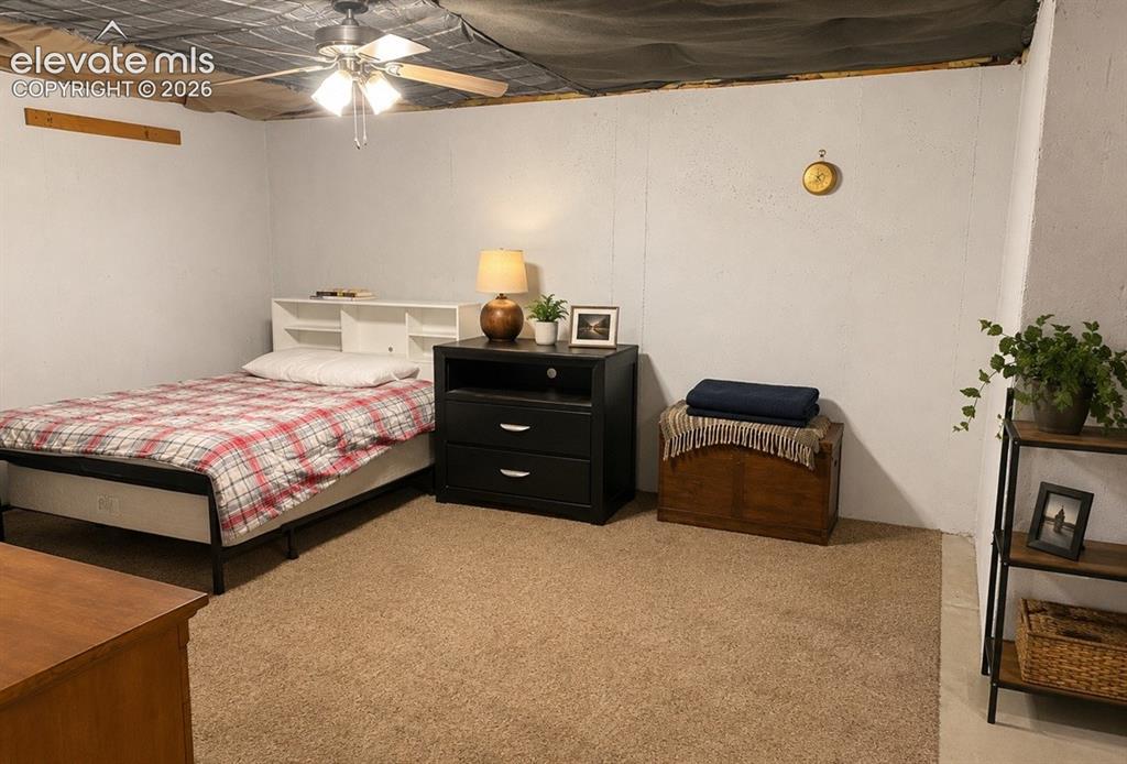 Image 17 of 20: Carpeted room featuring a ceiling fan, white paneled walls, and a recessed