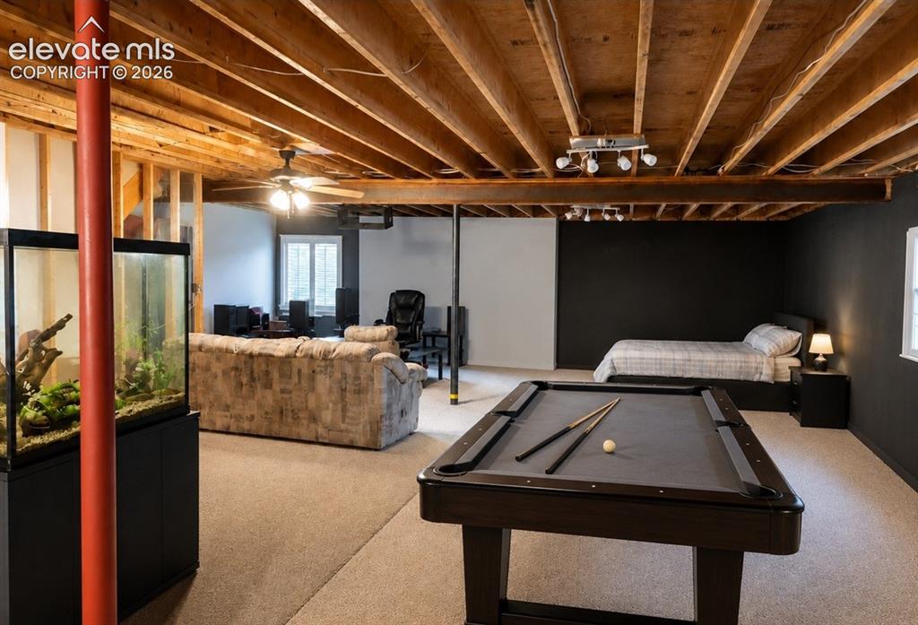 Image 18 of 20: Versatile lower level featuring exposed ceiling joists, light-colored carpe