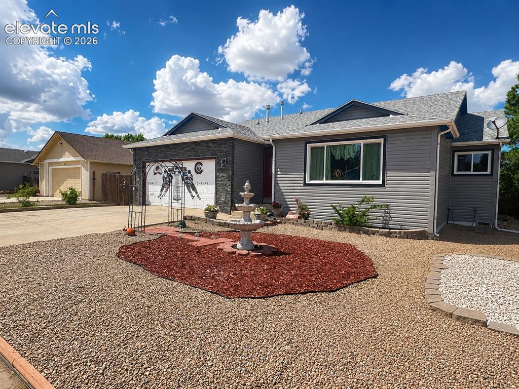Image 2 of 20: Single-story residence featuring gray siding with white trim, a dark gray s
