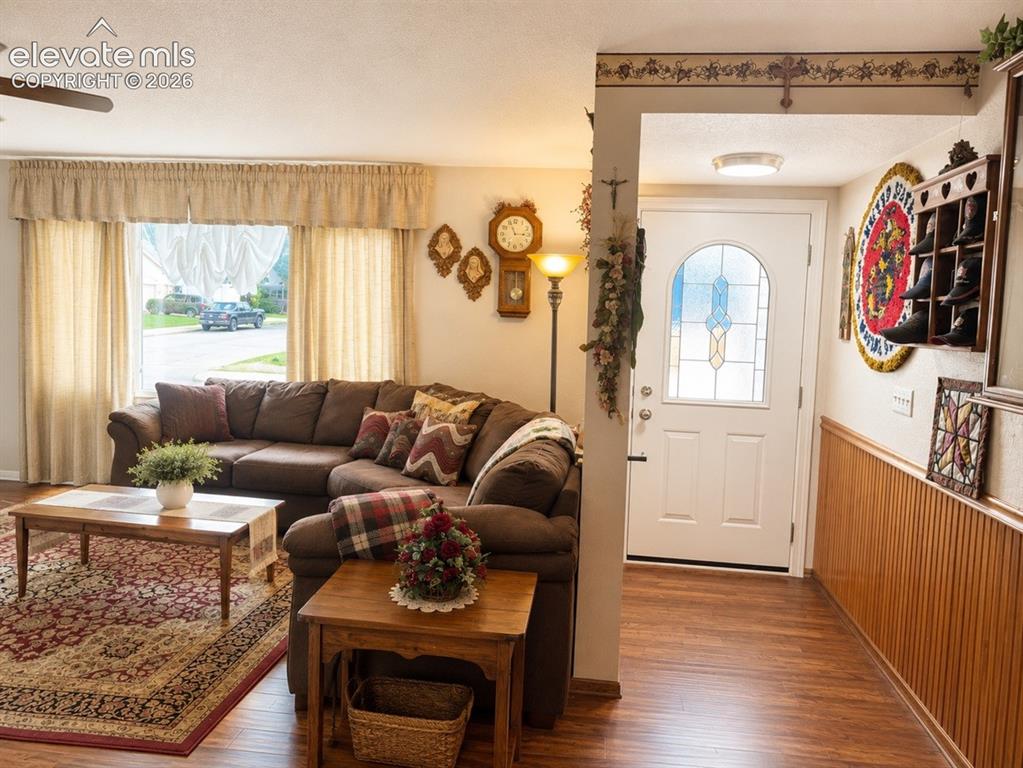 Image 4 of 20: Entryway featuring a white door with decorative glass inserts, wood-finish