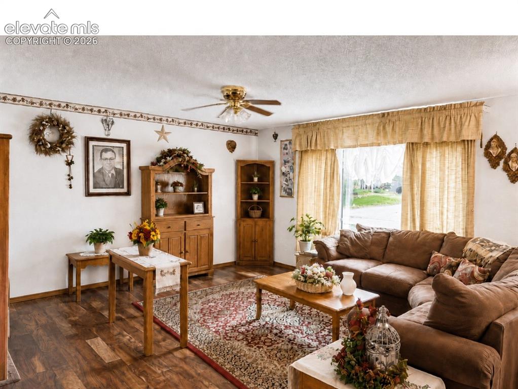 Image 5 of 20: Spacious living area featuring wood-finish flooring, a contemporary ceiling