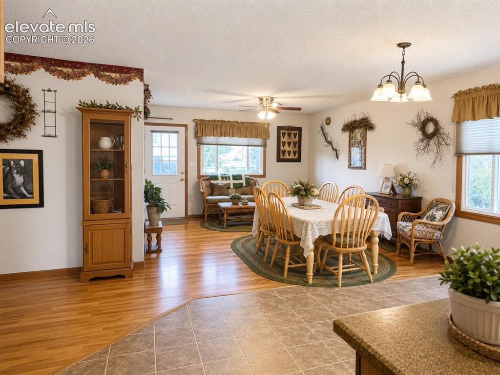 Image 8 of 20: Open concept living and dining areas featuring wood-finish flooring, a ceil