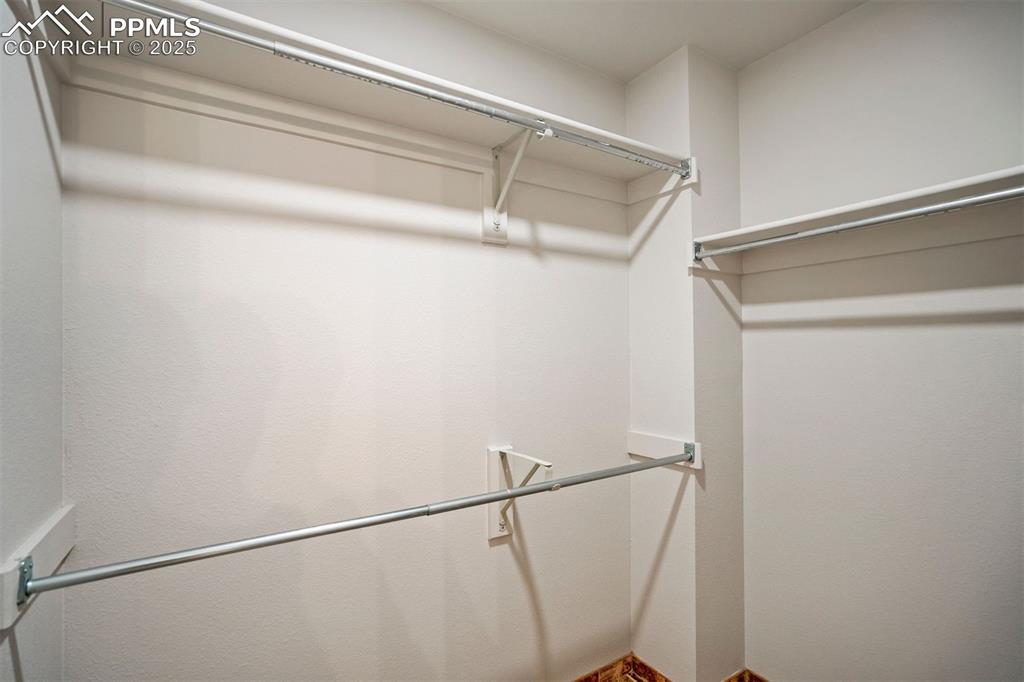 Image 28 of 50: Upper level primary walk-in closet