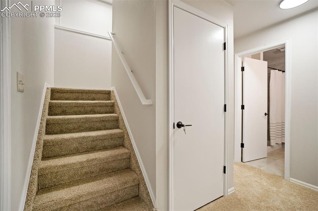 Image 30 of 50: The bathroom is to one side of the stairway and the bedroom is on the oppos