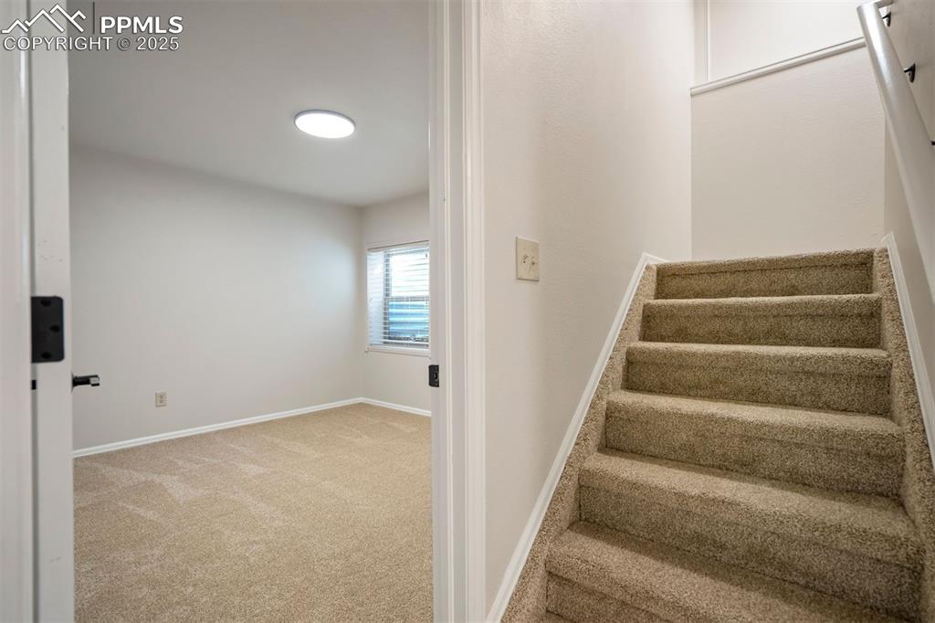 Image 34 of 50: Preview of the basement bedroom off of the stairway.