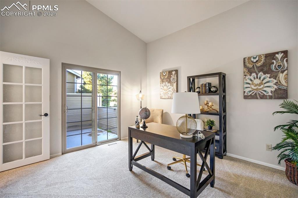 Image 7 of 50: This main level room is staged as an office, and can also be a bedroom with