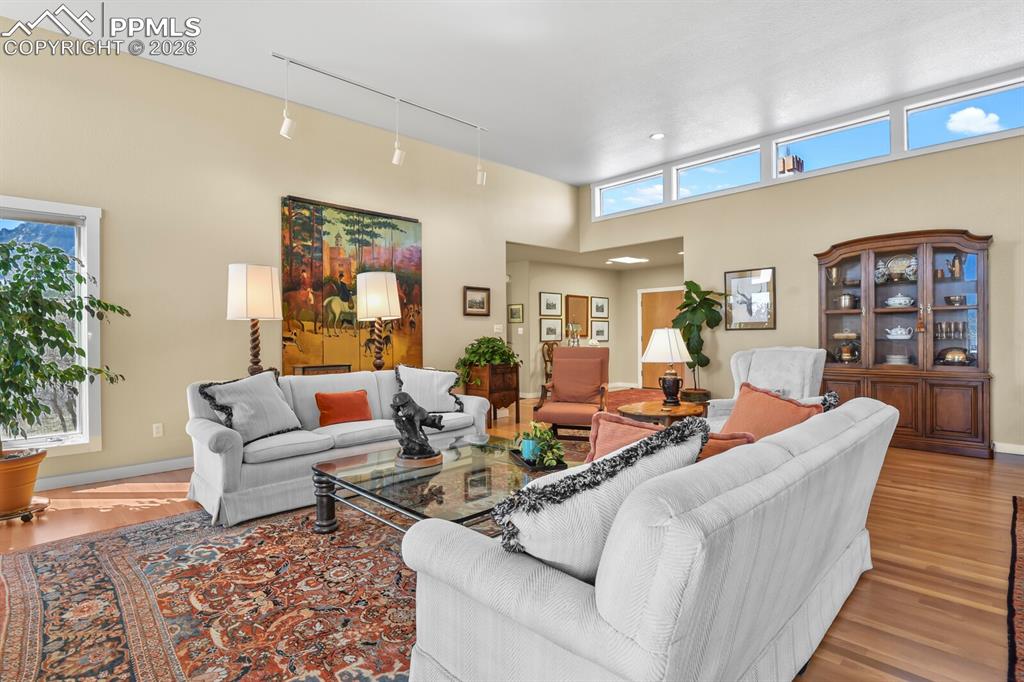 Image 10 of 50: Living Room looking towards the front entry. Hardwood floors.  Lots of wind