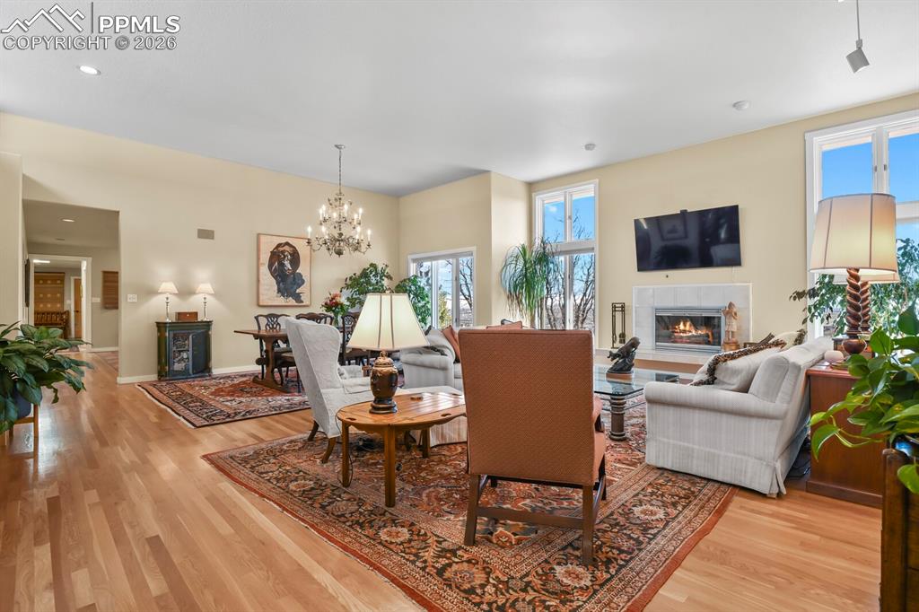 Image 11 of 50: Living Room, open to the Dining Area, with beautiful chandelier. Some canne