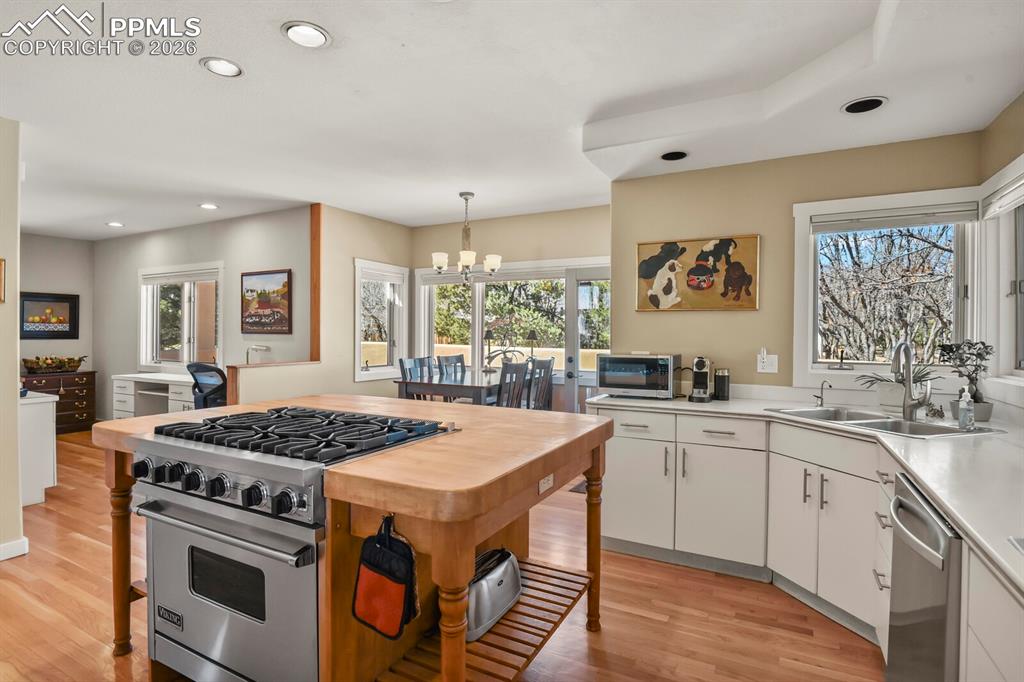Image 19 of 50: Kitchen with stainless steel appliances Viking gas hob and oven, showing th