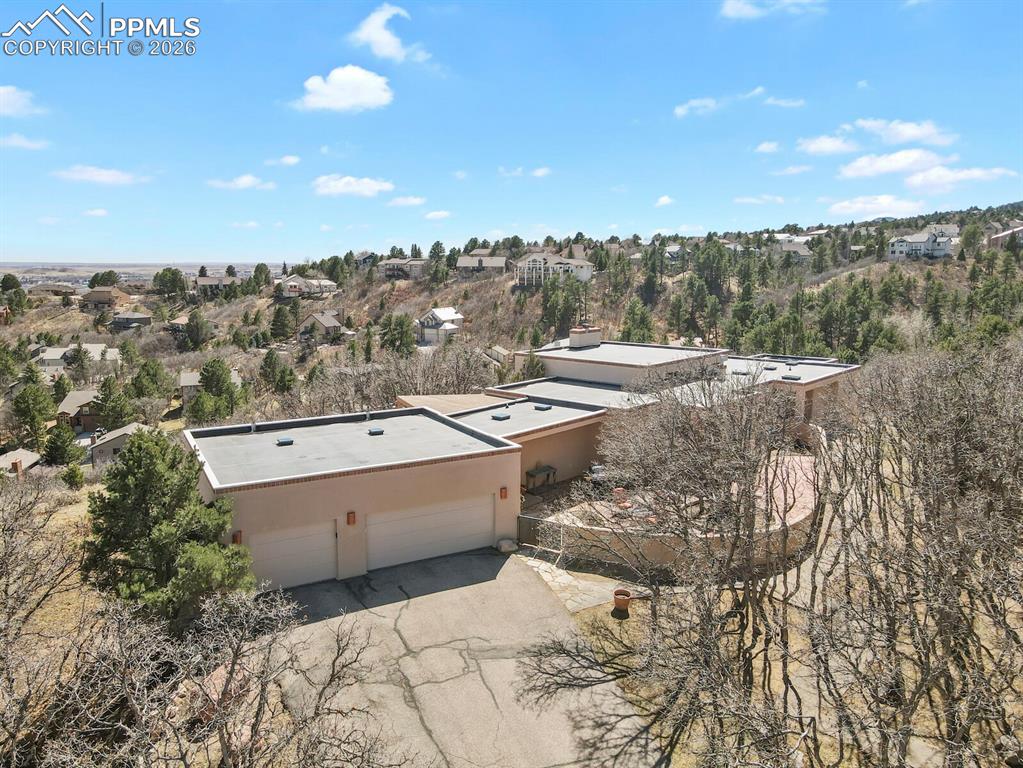 Image 2 of 50: View of the front section of the stucco ranch home, showing three car garag