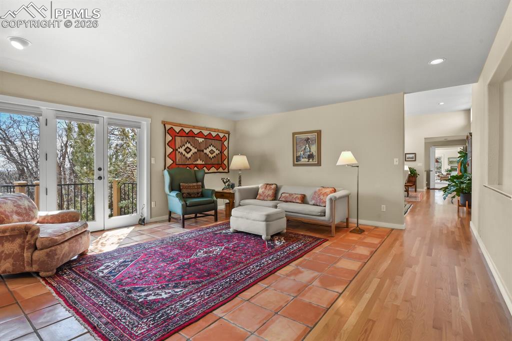 Image 21 of 50: Family Room with beautiful, practical Saltillo tile, and french doors to th