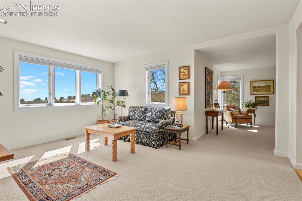 Image 24 of 50: This is the sitting room that is part of the Primary Suite.  leading to the