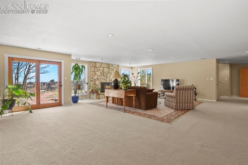 Image 32 of 50: Another view of the 2nd Family Room, french doors, and light color carpet, 