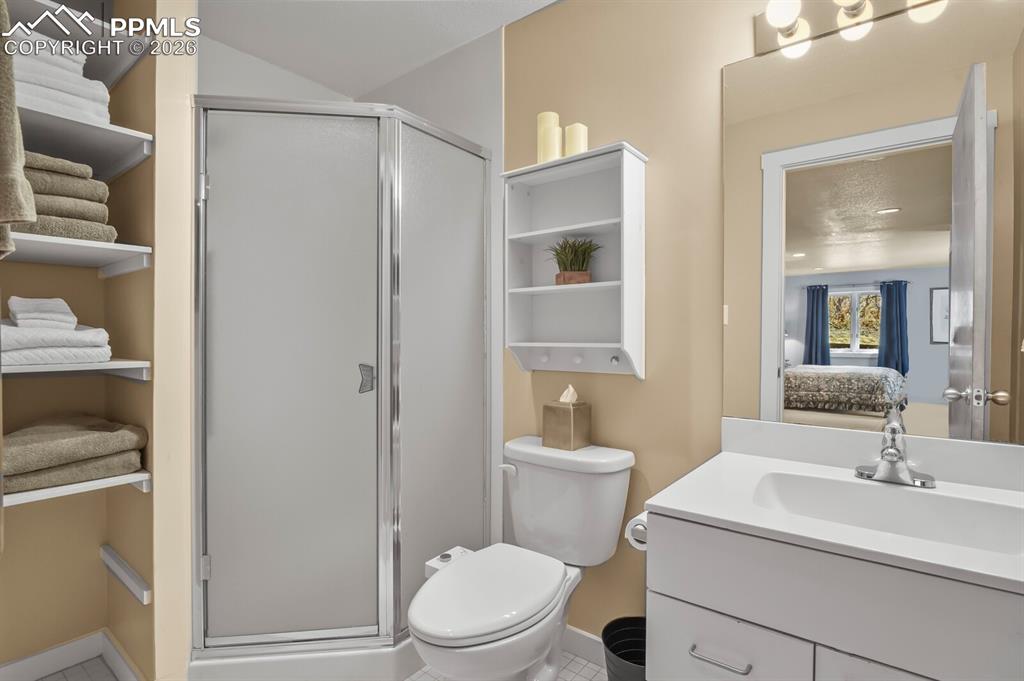 Image 39 of 50: Ensuite bathroom to the secondary bedroom suite.  With shower and single va