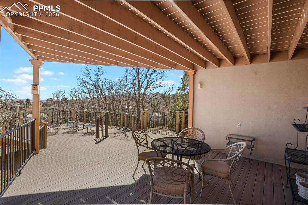 Image 43 of 50: Covered area and the full deck looking towards the wrought iron railings an
